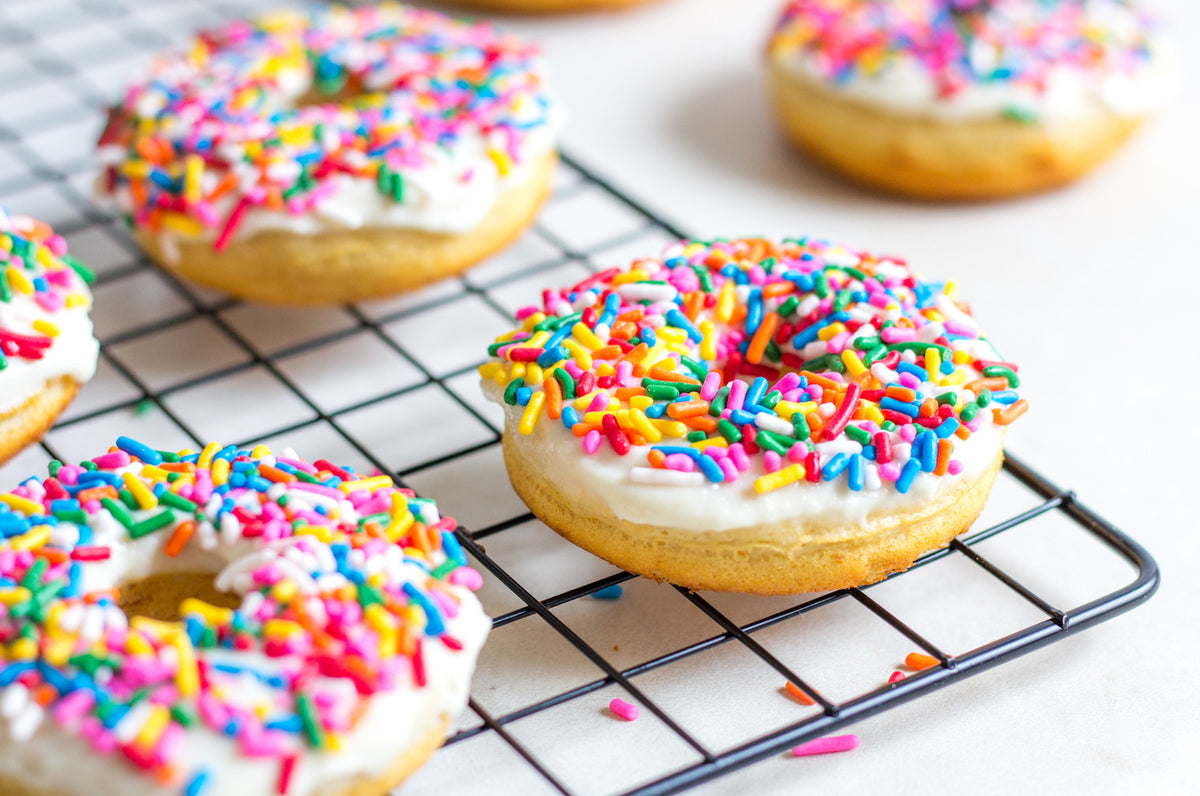 Vanilla Frosted Doughnuts With Sprinkles